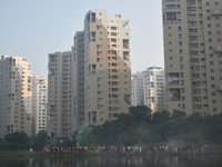 People celebrate the Chhath festival on a polluted, smoggy morning in Kolkata, India, on November 8, 2024. (