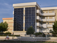 A modern residential building in Margherita di Savoia, Italy, on November 8, 2024, features an innovative photovoltaic facade for sustainabl...