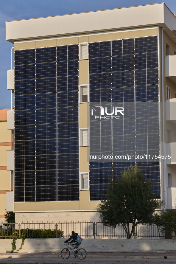 A modern residential building in Margherita di Savoia, Italy, on November 8, 2024, features an innovative photovoltaic facade for sustainabl...