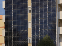 A modern residential building in Margherita di Savoia, Italy, on November 8, 2024, features an innovative photovoltaic facade for sustainabl...