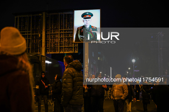 Soviet soldier picture at Checkpoint Charlie memorial site a day ahead of the 35th anniversary of the fall of the Berlin Wall. Berlin, Germa...