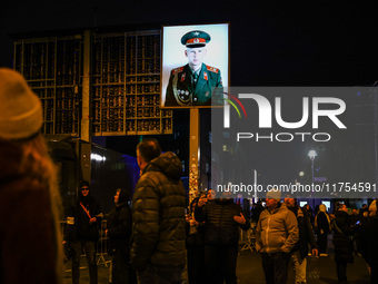 Soviet soldier picture at Checkpoint Charlie memorial site a day ahead of the 35th anniversary of the fall of the Berlin Wall. Berlin, Germa...