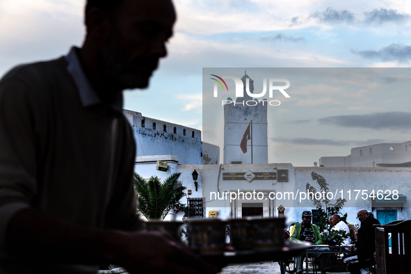 A man delivers coffee in a coffee shop in an Old Town of Kairouan in central Tunisia on October 31, 2024. 