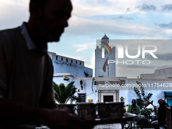 A man delivers coffee in a coffee shop in an Old Town of Kairouan in central Tunisia on October 31, 2024. (