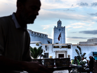 A man delivers coffee in a coffee shop in an Old Town of Kairouan in central Tunisia on October 31, 2024. (