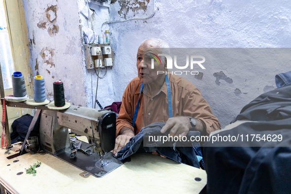 A tailor works in his workshop in an Old Town of Kairouan in central Tunisia on October 31, 2024. 