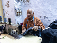 A tailor works in his workshop in an Old Town of Kairouan in central Tunisia on October 31, 2024. (