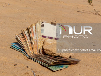 Tunisian Dinar is seen on a sand in Douz in Sahara desert, Tunisia on October 30, 2024. (