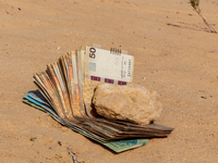 Tunisian Dinar is seen on a sand in Douz in Sahara desert, Tunisia on October 30, 2024. (