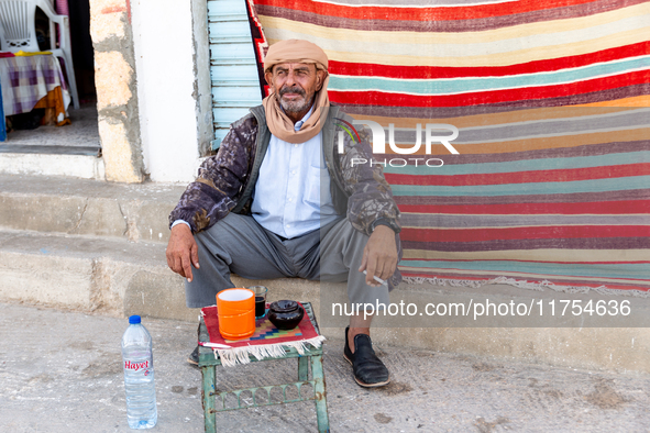 A man sits on a street wit his tea in Tozeur in central Tunisia on October 29, 2024. 