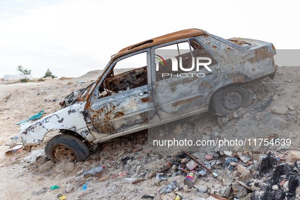 A burned car is seen on a street in Tozeur in central Tunisia on October 28, 2024. 