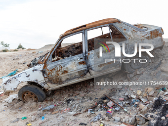 A burned car is seen on a street in Tozeur in central Tunisia on October 28, 2024. (