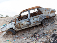 A burned car is seen on a street in Tozeur in central Tunisia on October 28, 2024. (