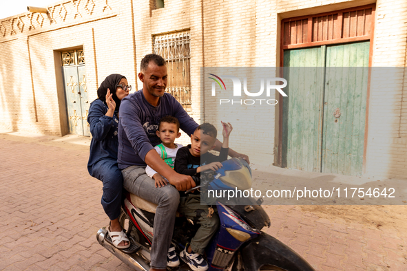 A family rides on a motorbike in Medina of Tozeur in central Tunisia on October 28, 2024. 