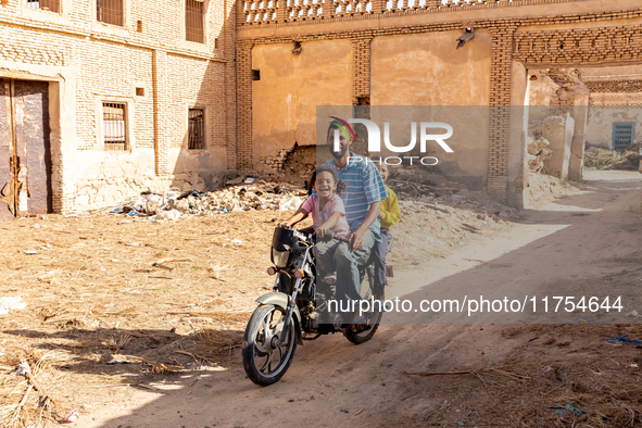 A family rides on a motorbike in Medina of Tozeur in central Tunisia on October 28, 2024. 