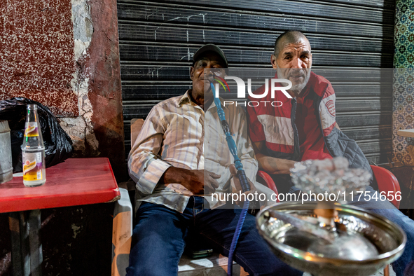 Men smoke shisha in an Old Town of Tunis, the capital of Tunisia on November 2, 2024. 