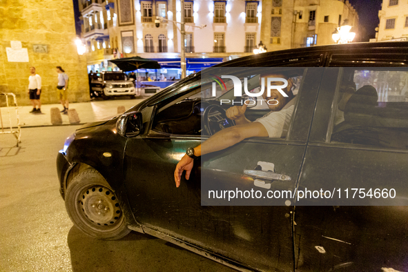 A man drives a car in an Old Town of Tunis, the capital of Tunisia on November 2, 2024. 