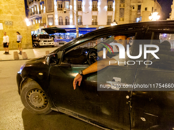 A man drives a car in an Old Town of Tunis, the capital of Tunisia on November 2, 2024. (