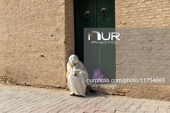 A woman begs in an Old Town of Kairouan in central Tunisia on October30, 2024. 