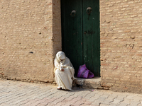 A woman begs in an Old Town of Kairouan in central Tunisia on October30, 2024. (