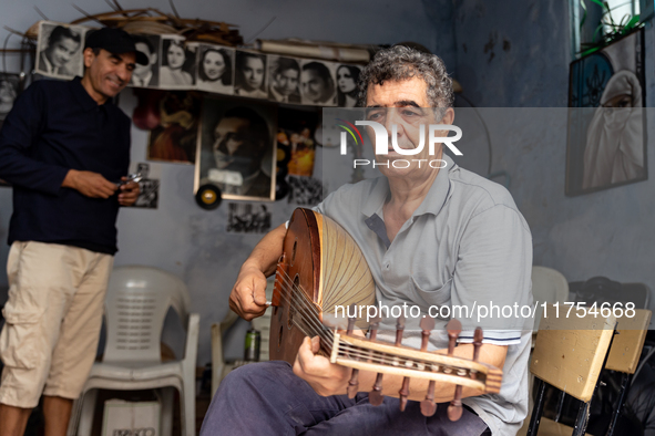 Oud player plays in his workshop in an Old Town of Kairouan in central Tunisia on October30, 2024. 