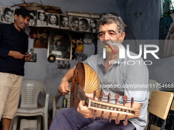 Oud player plays in his workshop in an Old Town of Kairouan in central Tunisia on October30, 2024. (