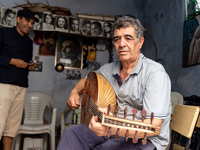 Oud player plays in his workshop in an Old Town of Kairouan in central Tunisia on October30, 2024. (