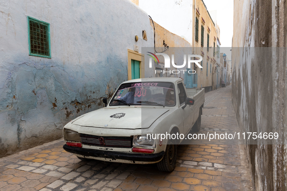 Old Peugeot drives nerrow streets of an Old Town of Kairouan in central Tunisia on October30, 2024. 