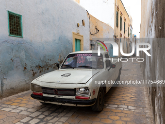 Old Peugeot drives nerrow streets of an Old Town of Kairouan in central Tunisia on October30, 2024. (