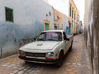 Old Peugeot drives nerrow streets of an Old Town of Kairouan in central Tunisia on October30, 2024. (