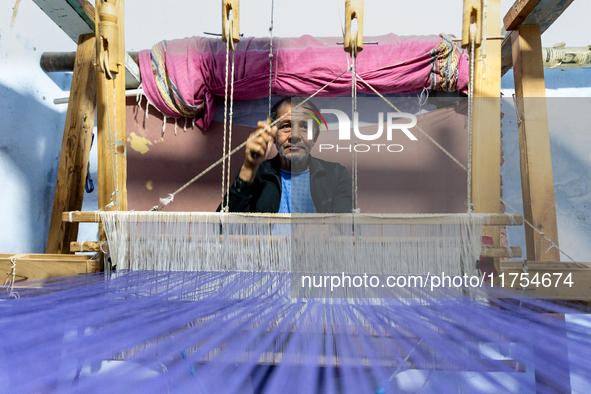 Weaver works in his workshop in an Old Town of Kairouan in central Tunisia on October 31, 2024. 