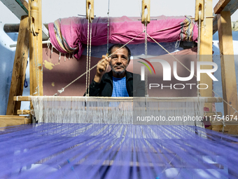 Weaver works in his workshop in an Old Town of Kairouan in central Tunisia on October 31, 2024. (