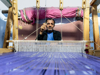 Weaver works in his workshop in an Old Town of Kairouan in central Tunisia on October 31, 2024. (