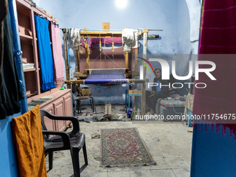 Weaver works in his workshop in an Old Town of Kairouan in central Tunisia on October 31, 2024. (