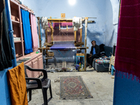 Weaver works in his workshop in an Old Town of Kairouan in central Tunisia on October 31, 2024. (