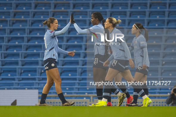 Khadija Shaw #21 of Manchester City W.F.C celebrates her goal with teammates during the Barclays FA Women's Super League match between Manch...