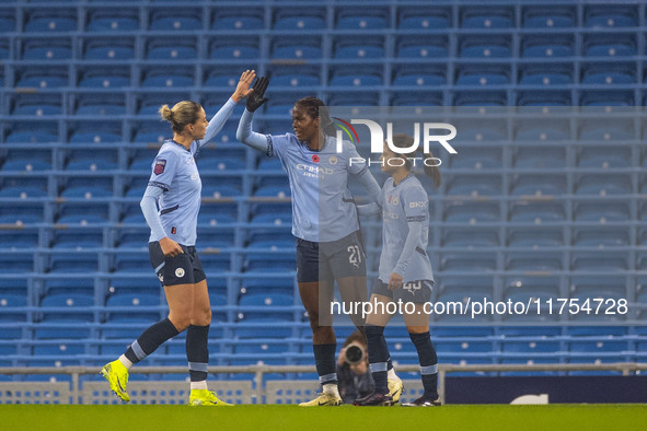 Khadija Shaw #21 of Manchester City W.F.C celebrates her goal with teammates during the Barclays FA Women's Super League match between Manch...