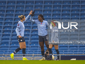 Khadija Shaw #21 of Manchester City W.F.C celebrates her goal with teammates during the Barclays FA Women's Super League match between Manch...