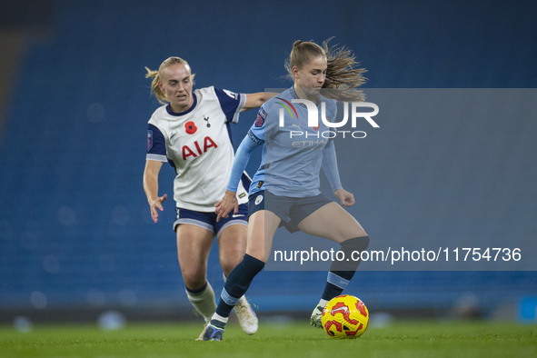 Jess Park, number 16 of Manchester City W.F.C., is tackled by an opponent during the Barclays FA Women's Super League match between Manchest...