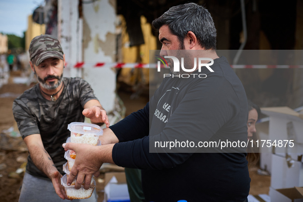 Volunteers deliver food in Benetusser, Spain, on november 08, 2024, due to the flood 