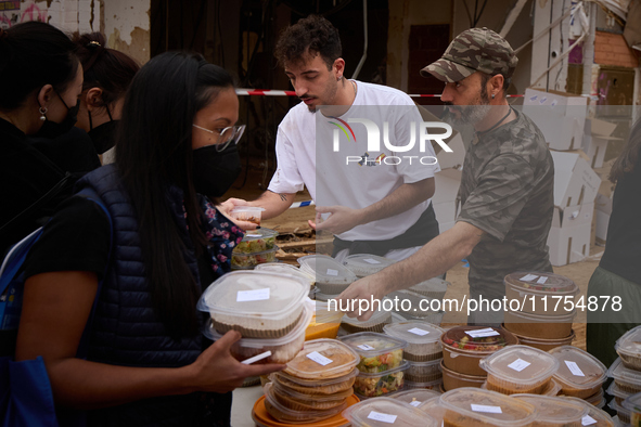 Volunteers deliver food in Benetusser, Spain, on november 08, 2024, due to the flood 