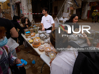 Volunteers deliver food in Benetusser, Spain, on november 08, 2024, due to the flood (