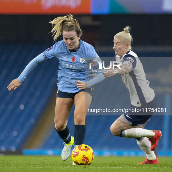 Lauren Hemp #11 of Manchester City W.F.C. is tackled by the opponent during the Barclays FA Women's Super League match between Manchester Ci...