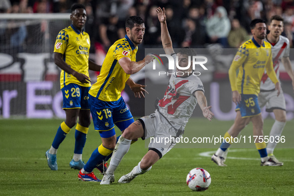 Scott McKenna of UD Las Palmas (L) is in action against Florian Lejeune of Rayo Vallecano (R) during the La Liga EA Sports 2024/25 football...