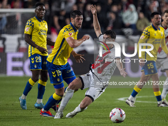 Scott McKenna of UD Las Palmas (L) is in action against Florian Lejeune of Rayo Vallecano (R) during the La Liga EA Sports 2024/25 football...