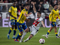 Scott McKenna of UD Las Palmas (L) is in action against Florian Lejeune of Rayo Vallecano (R) during the La Liga EA Sports 2024/25 football...