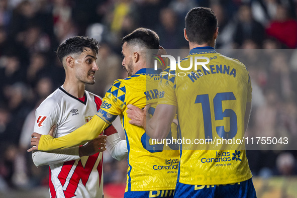 Oscar Valentin of Rayo Vallecano argues with Kirian Rodriguez and Scott McKenna of UD Las Palmas during the La Liga EA Sports 2024/25 footba...