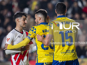 Oscar Valentin of Rayo Vallecano argues with Kirian Rodriguez and Scott McKenna of UD Las Palmas during the La Liga EA Sports 2024/25 footba...