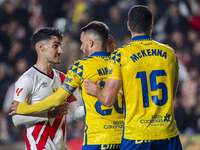 Oscar Valentin of Rayo Vallecano argues with Kirian Rodriguez and Scott McKenna of UD Las Palmas during the La Liga EA Sports 2024/25 footba...