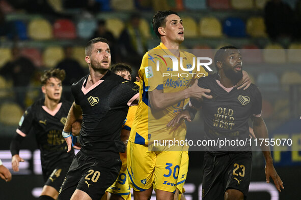 Thomas Henry of Palermo F.C., Ilario Monterisi of Frosinone Calcio, and Salim Diakite of Palermo F.C. participate during the 13th day of the...